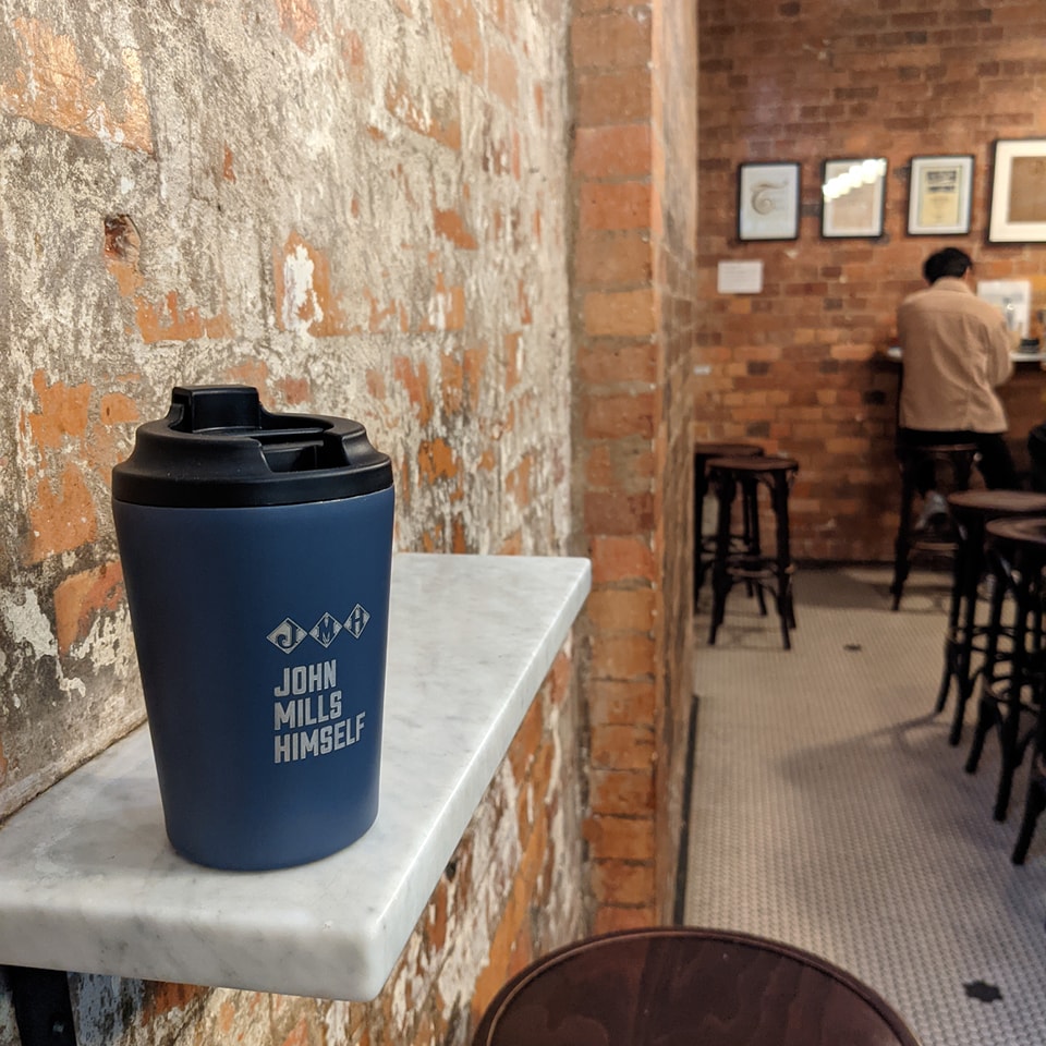 Branded keep cup in cafe interior